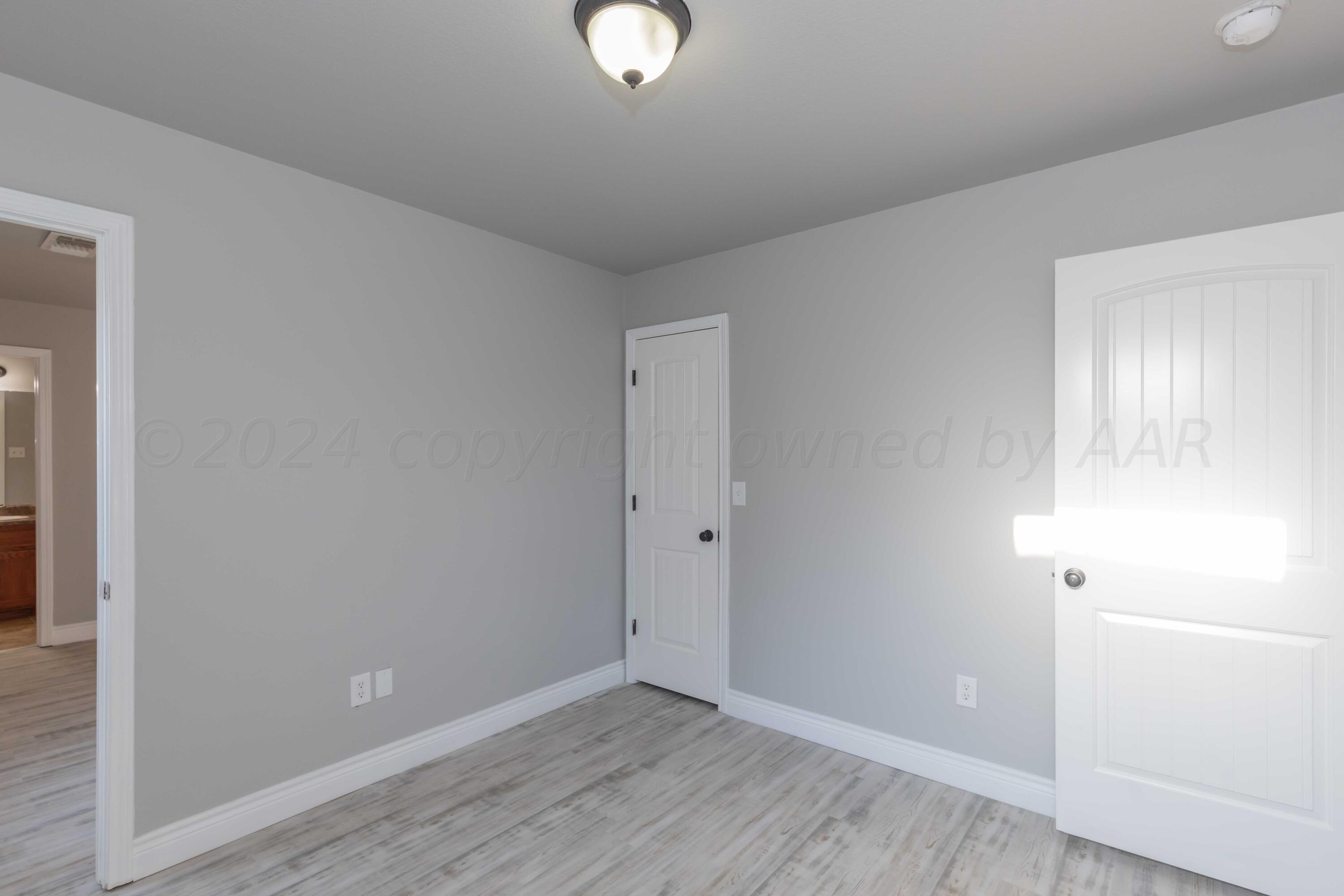2805 Ries Lane Amarillo, TX 79118 - Photo 30 of 38 a view of an empty room with wooden floor and a window