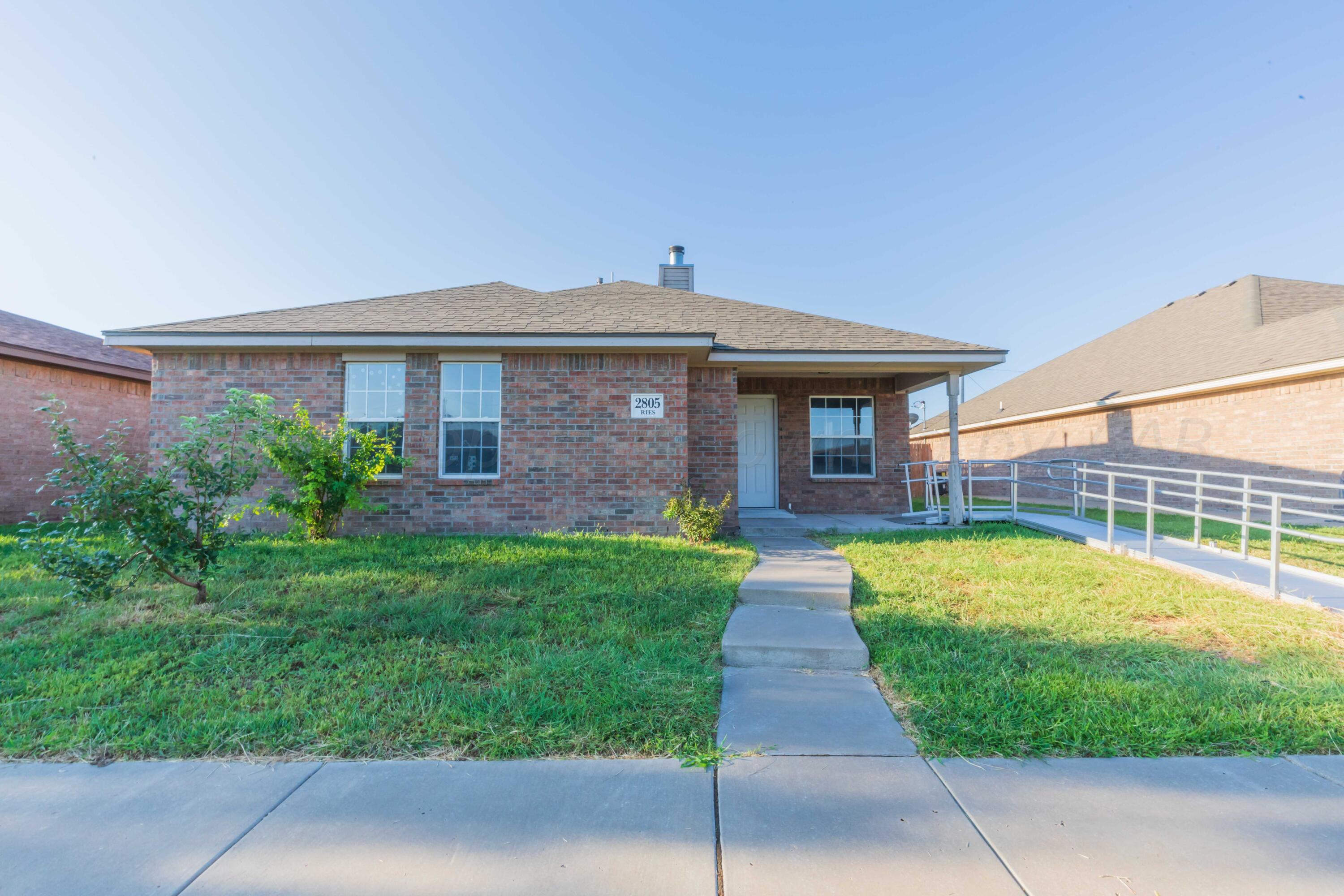 2805 Ries Lane Amarillo, TX 79118 - Photo 37 of 38 a front view of a house with a yard and porch