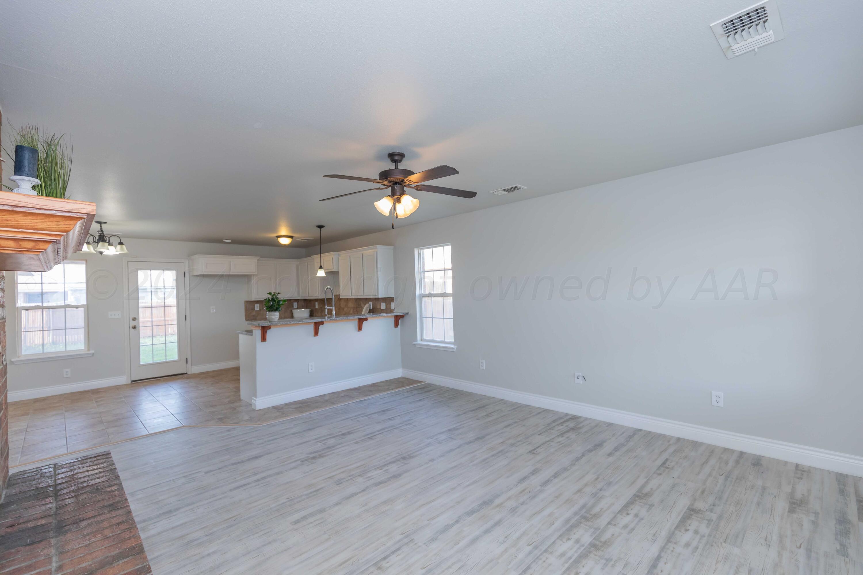2805 Ries Lane Amarillo, TX 79118 - Photo 5 of 38 wooden floor in an empty room with a window