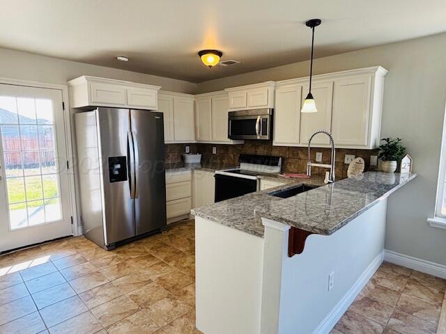 2805 Ries Lane Amarillo, TX 79118 - Photo 7 of 38 a kitchen with stainless steel appliances granite countertop a refrigerator a sink a stove a microwave and island