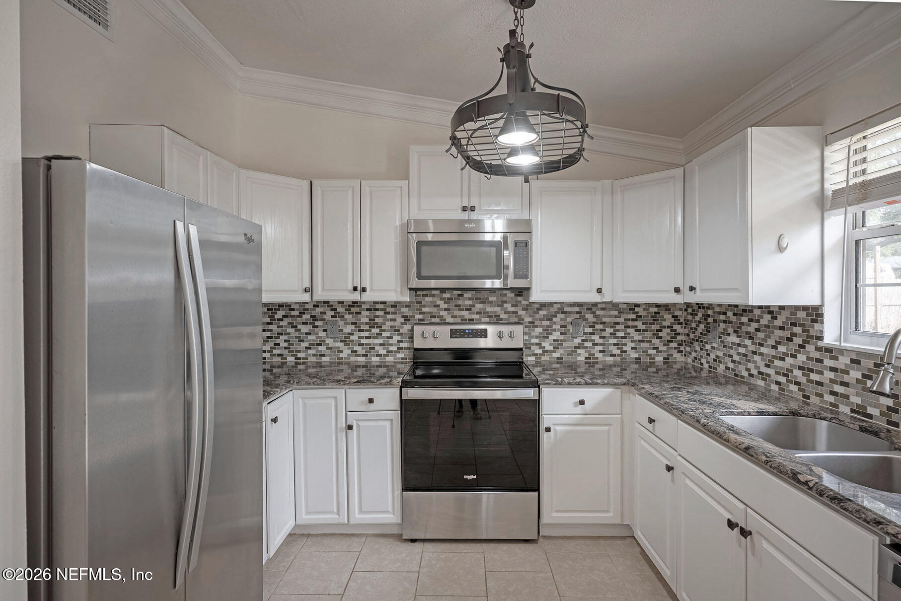 430 Southwest Jasmine Avenue Keystone Heights, FL 32656 - Photo 11 of 35 a kitchen with stainless steel appliances granite countertop a stove a refrigerator and a sink