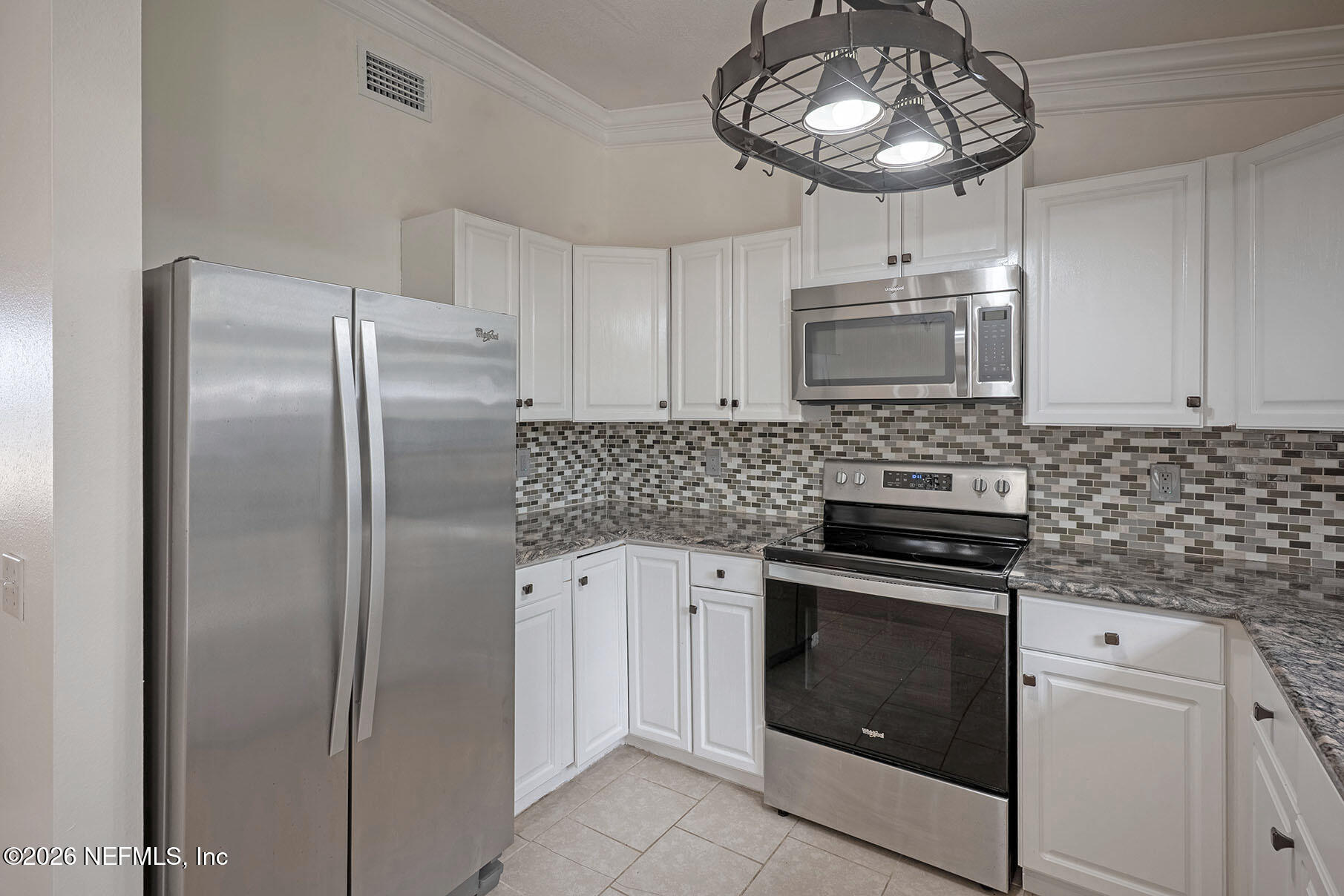 430 Southwest Jasmine Avenue Keystone Heights, FL 32656 - Photo 13 of 35 a kitchen with cabinets stainless steel appliances and a counter space