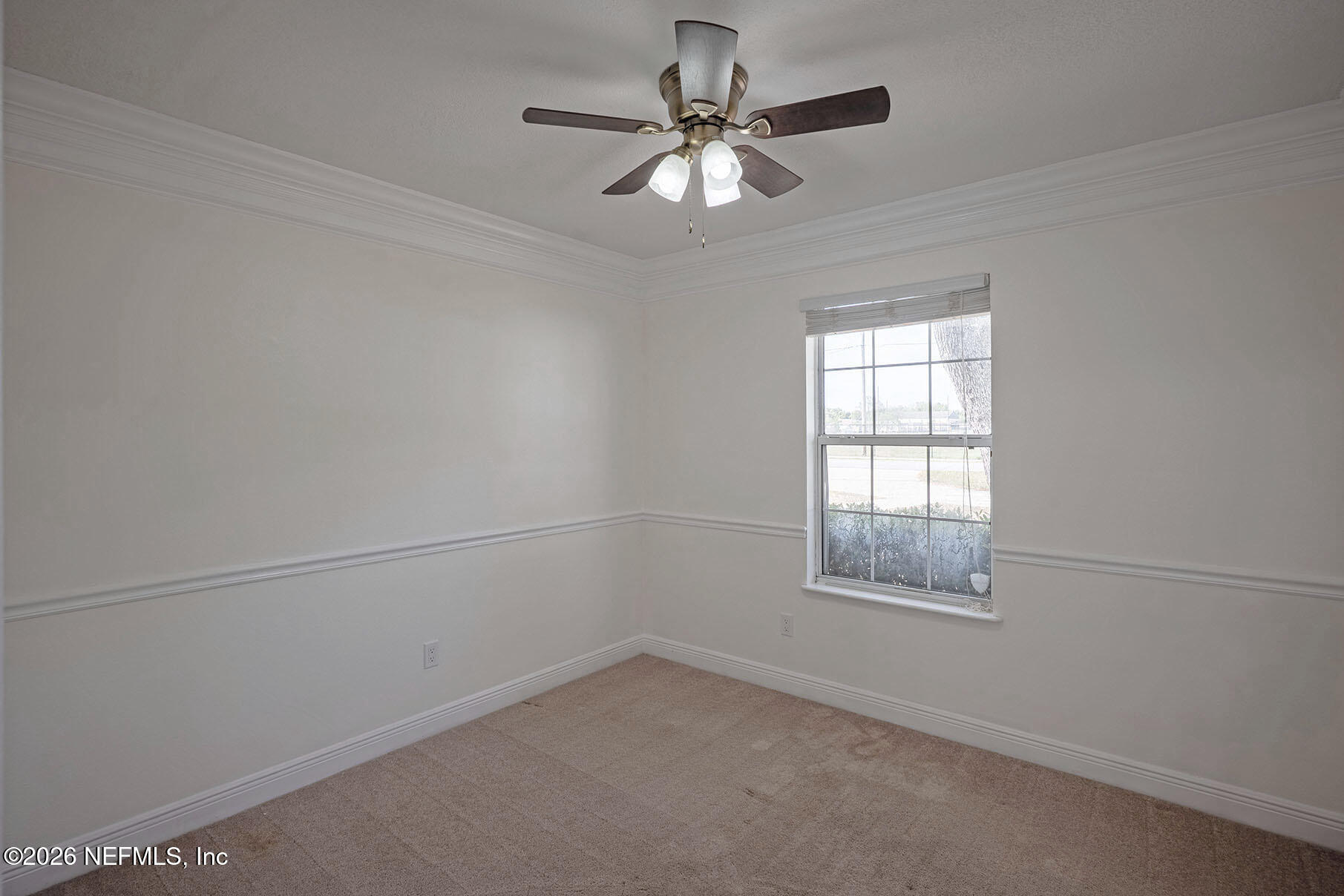 430 Southwest Jasmine Avenue Keystone Heights, FL 32656 - Photo 18 of 35 an empty room with a window and a ceiling fan