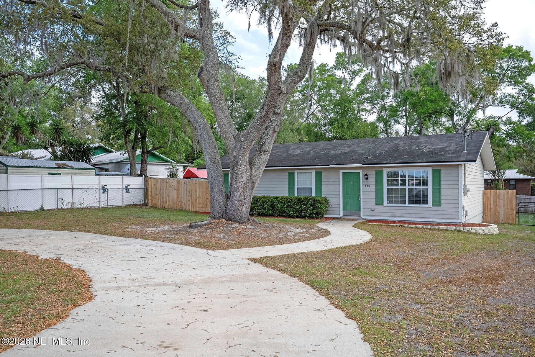 430 Southwest Jasmine Avenue Keystone Heights, FL 32656 - Photo 2 of 35 a front view of a house with a yard and garage
