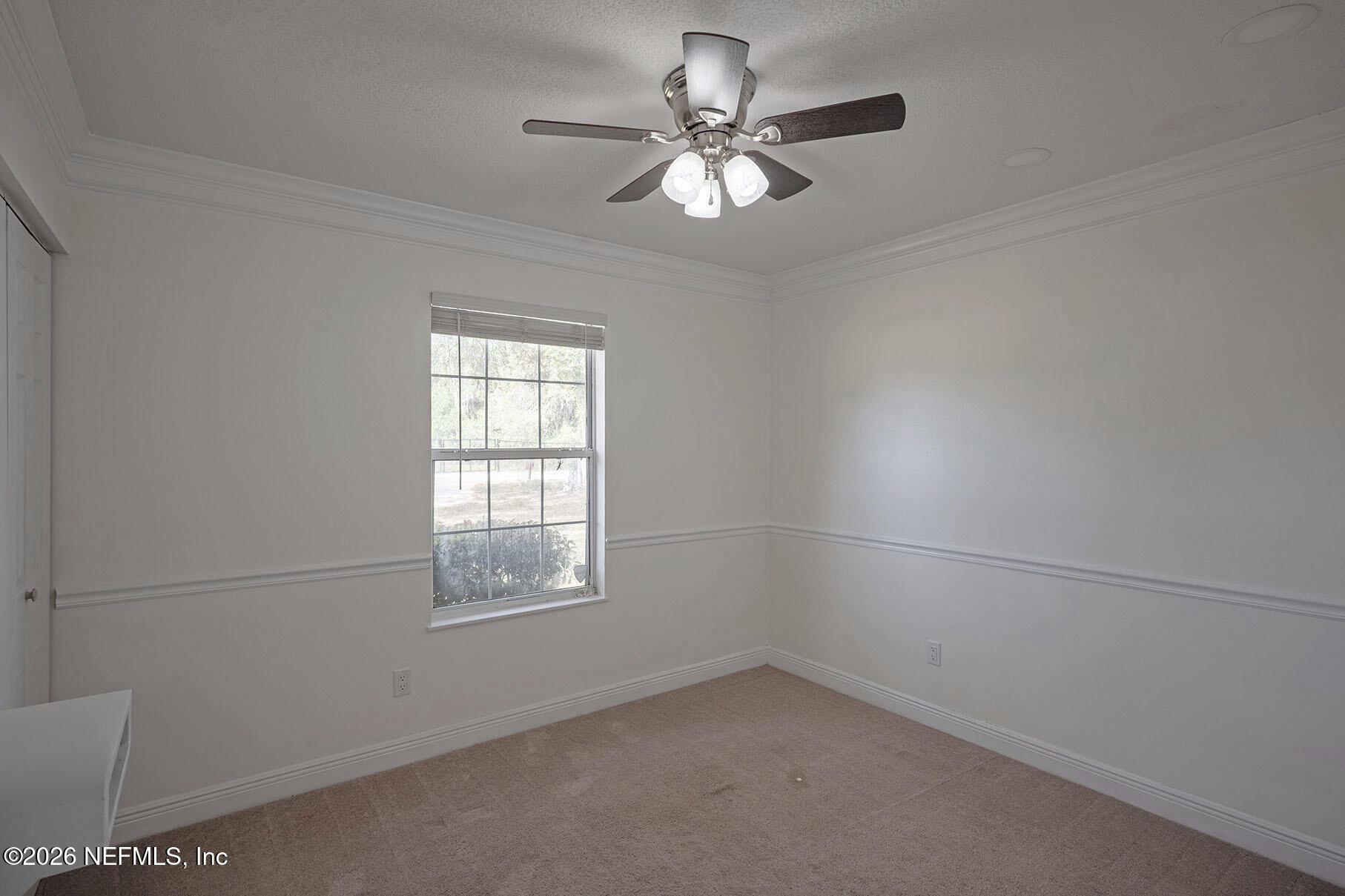 430 Southwest Jasmine Avenue Keystone Heights, FL 32656 - Photo 22 of 37 an empty room with a window and a fan
