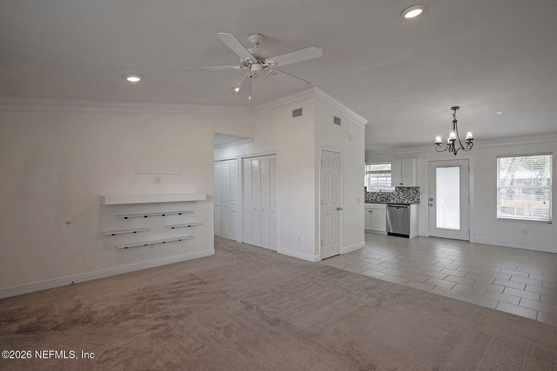 430 Southwest Jasmine Avenue Keystone Heights, FL 32656 - Photo 7 of 35 wooden floor in an empty room with a kitchen