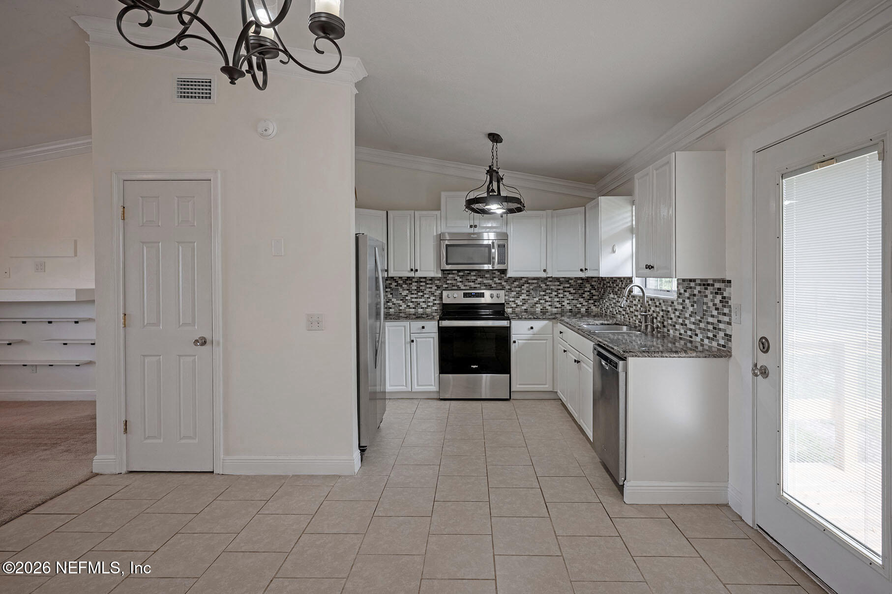 430 Southwest Jasmine Avenue Keystone Heights, FL 32656 - Photo 10 of 35 a kitchen with stainless steel appliances granite countertop a stove a sink and a refrigerator