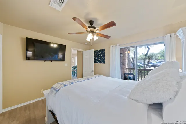 a bedroom with a bed and a flat screen tv