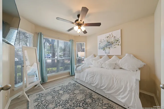 a living room with a bed furniture and a chandelier