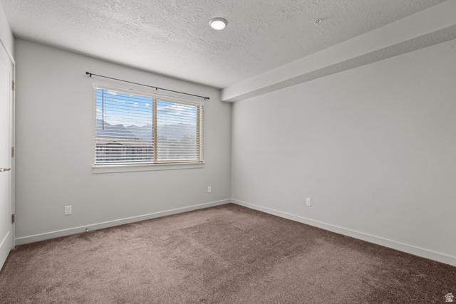 1700 South Sandhill Road West, Unit E 301 Orem, UT 84058 - Photo 12 of 20 Carpeted room featuring light gray walls, a window with horizontal blinds, and a distant mountain scenery