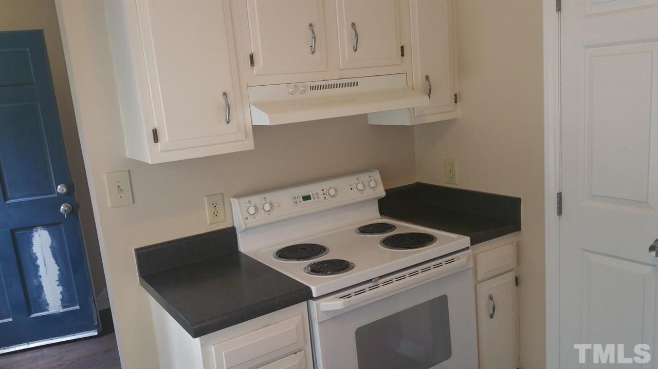 6430 English Oaks Drive Raleigh, NC 27615 - Photo 2 of 11 a kitchen with a stove and white cabinets