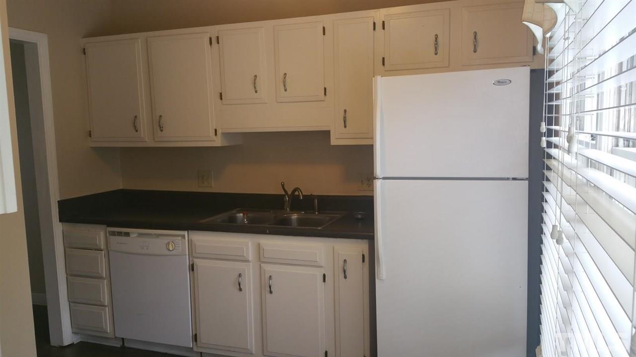 6430 English Oaks Drive Raleigh, NC 27615 - Photo 3 of 11 a kitchen with granite countertop white cabinets and refrigerator