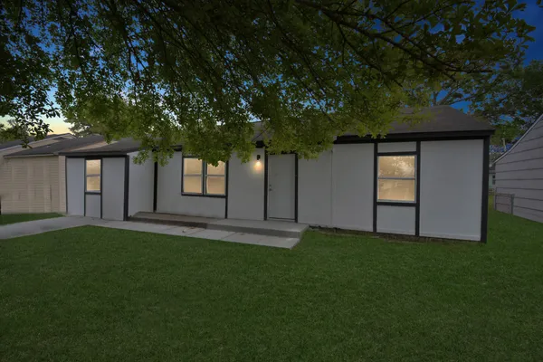 a backyard of a house with lots of green space and garden