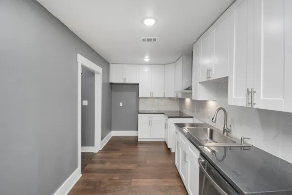 a kitchen with a sink stove and refrigerator