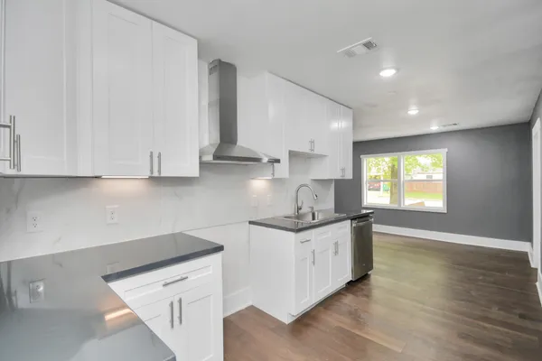 a kitchen with stainless steel appliances a sink stove and cabinets