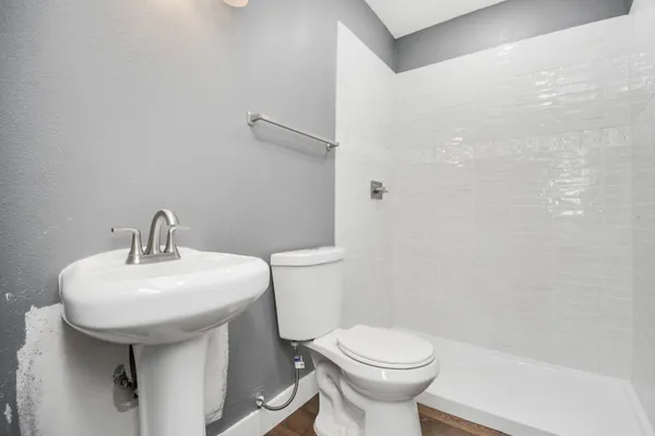 a bathroom with a sink toilet and a mirror