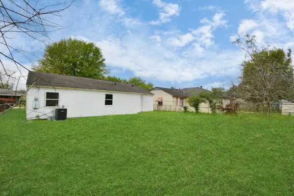 a view of a backyard with plants and a backyard
