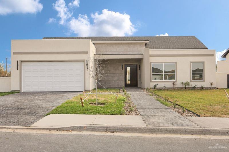 2305 Trinity Avenue McAllen, TX 78504 - Photo 1 of 24 a front view of a house with a yard and garage