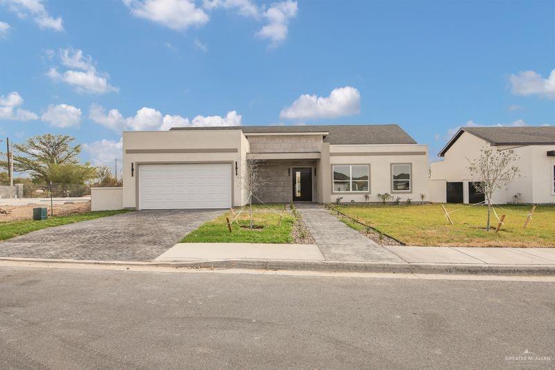 2305 Trinity Avenue McAllen, TX 78504 - Photo 2 of 24 a view of yellow house with a yard next to a road
