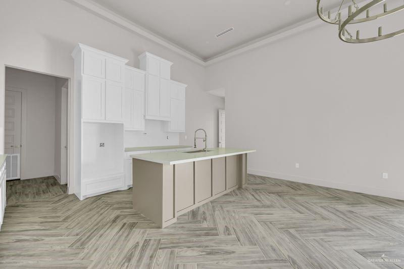 2305 Trinity Avenue McAllen, TX 78504 - Photo 6 of 24 a room with a washing machine and cabinets