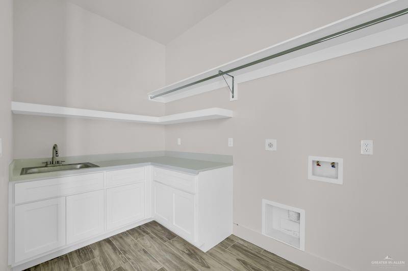 2305 Trinity Avenue McAllen, TX 78504 - Photo 7 of 24 a kitchen with a sink and cabinets