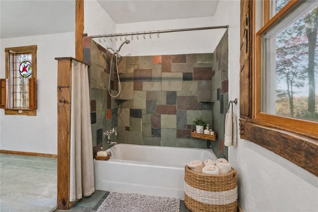 2123 Rocky Ridge Road Acme, PA 15610 - Photo 12 of 17 a bathroom with a bathtub and a shower