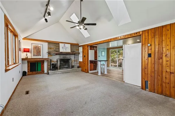 a view of a livingroom with an empty space and a fireplace