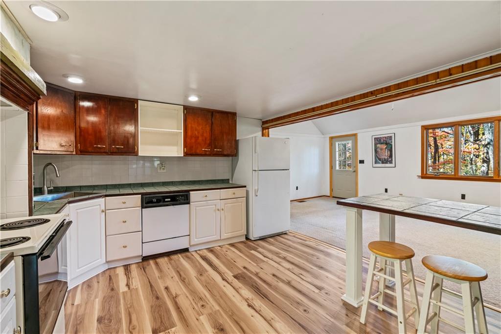 2123 Rocky Ridge Road Acme, PA 15610 - Photo 7 of 17 a large kitchen with stainless steel appliances kitchen island granite countertop a sink and cabinets