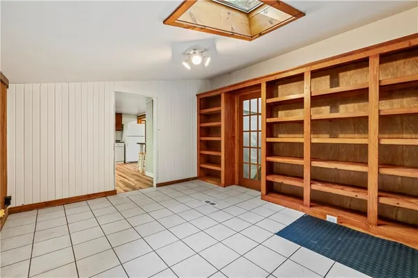 a bedroom with a bed and painting on the wall