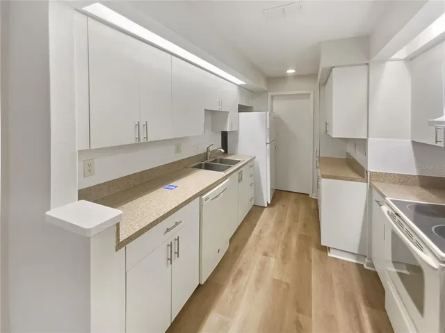a kitchen with a sink stove and cabinets