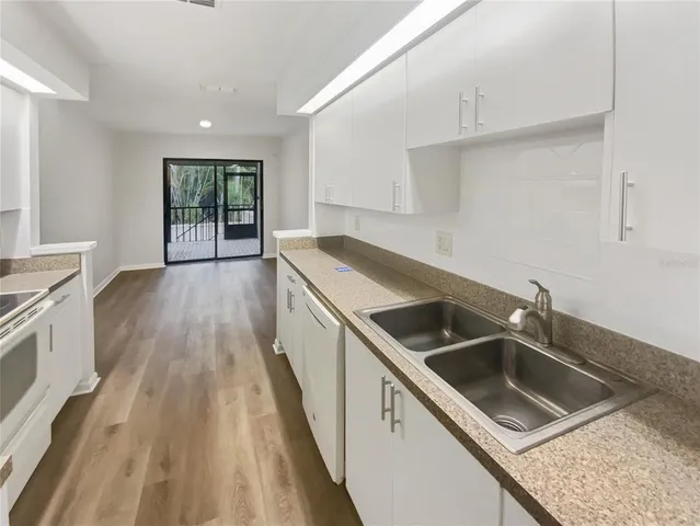 a kitchen that has a sink and a stove in it