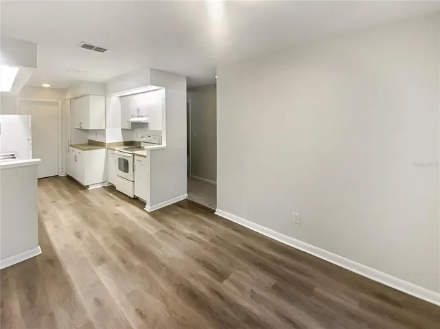 a view of a kitchen with wooden floor