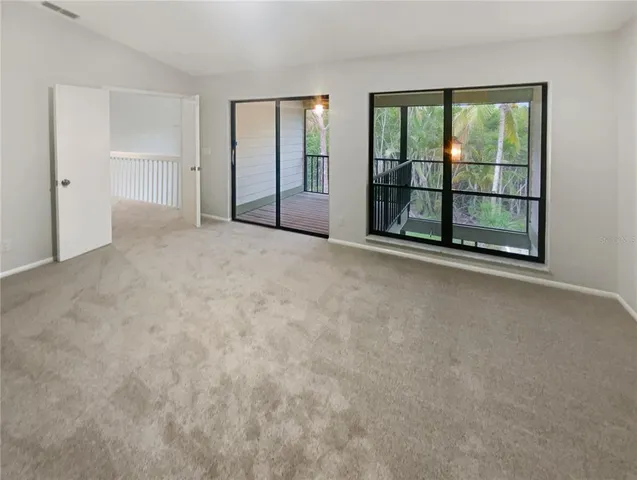 a view of a room with wooden floor and sliding door