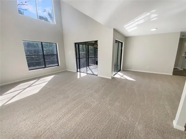 a view of an empty room with window and cabinet