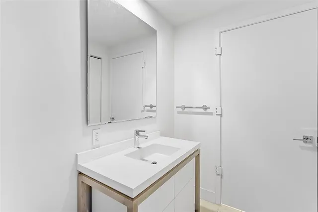 a bedroom with a bed and cabinet