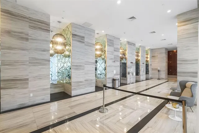 a living room with a large window and dining table
