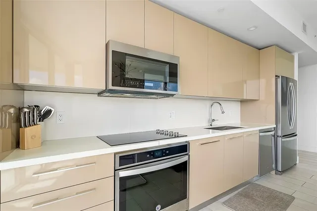 a kitchen with a sink stove and microwave