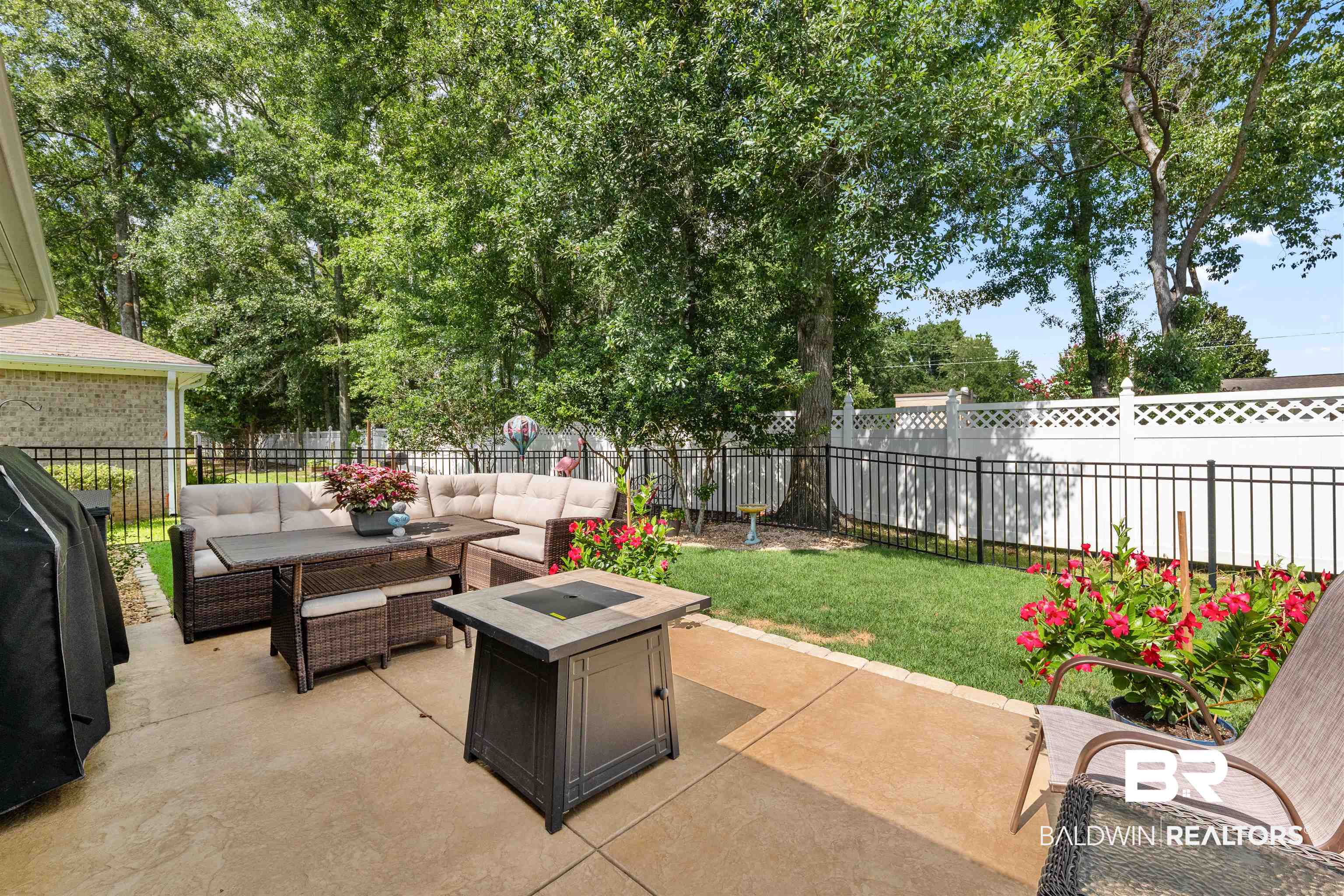 141 Mark Twain Loop Foley, AL 36535 - Photo 29 of 55 Fenced backyard featuring an outdoor living space with a fire pit, a patio, and a grill