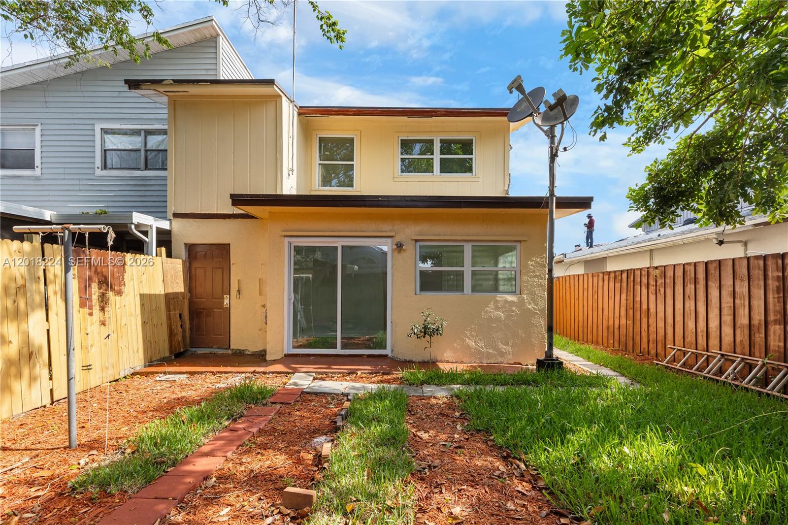 7958 Southwest 6th Street Pompano Beach, FL 33068 - Photo 46 of 57 a view of a house with a small yard and a large tree