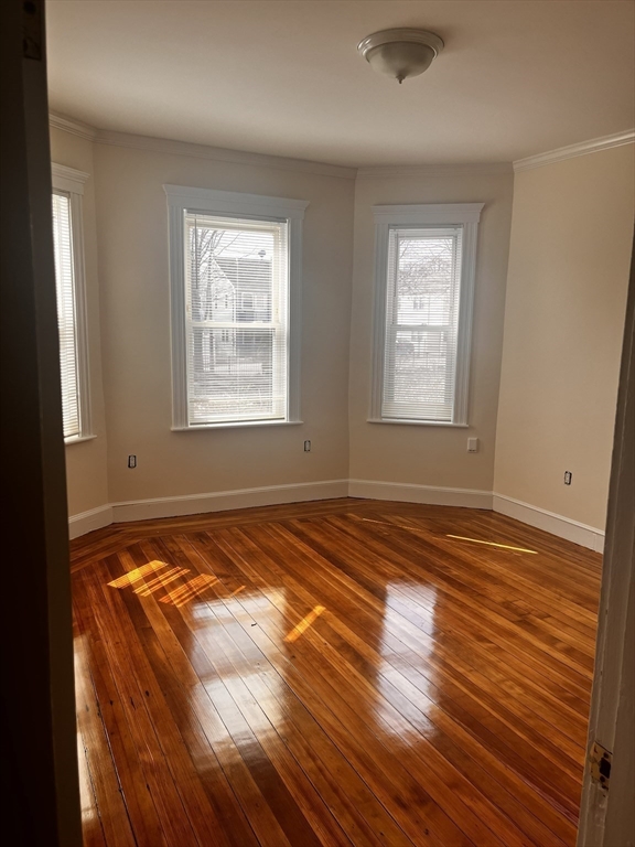 27 Irma Street, Unit 1 Boston, MA 02124 - Photo 4 of 8 a view of a room with wooden floor and window