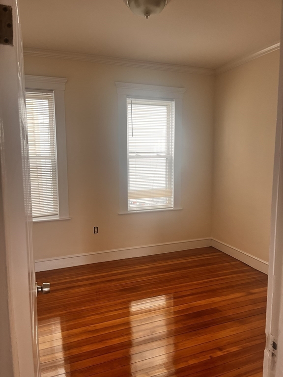 27 Irma Street, Unit 1 Boston, MA 02124 - Photo 6 of 8 a view of an empty room with wooden floor and a window
