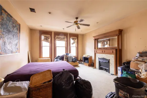 a spacious bedroom with a bed dresser and a chair