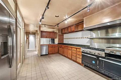 a kitchen with stainless steel appliances a stove a refrigerator and cabinets