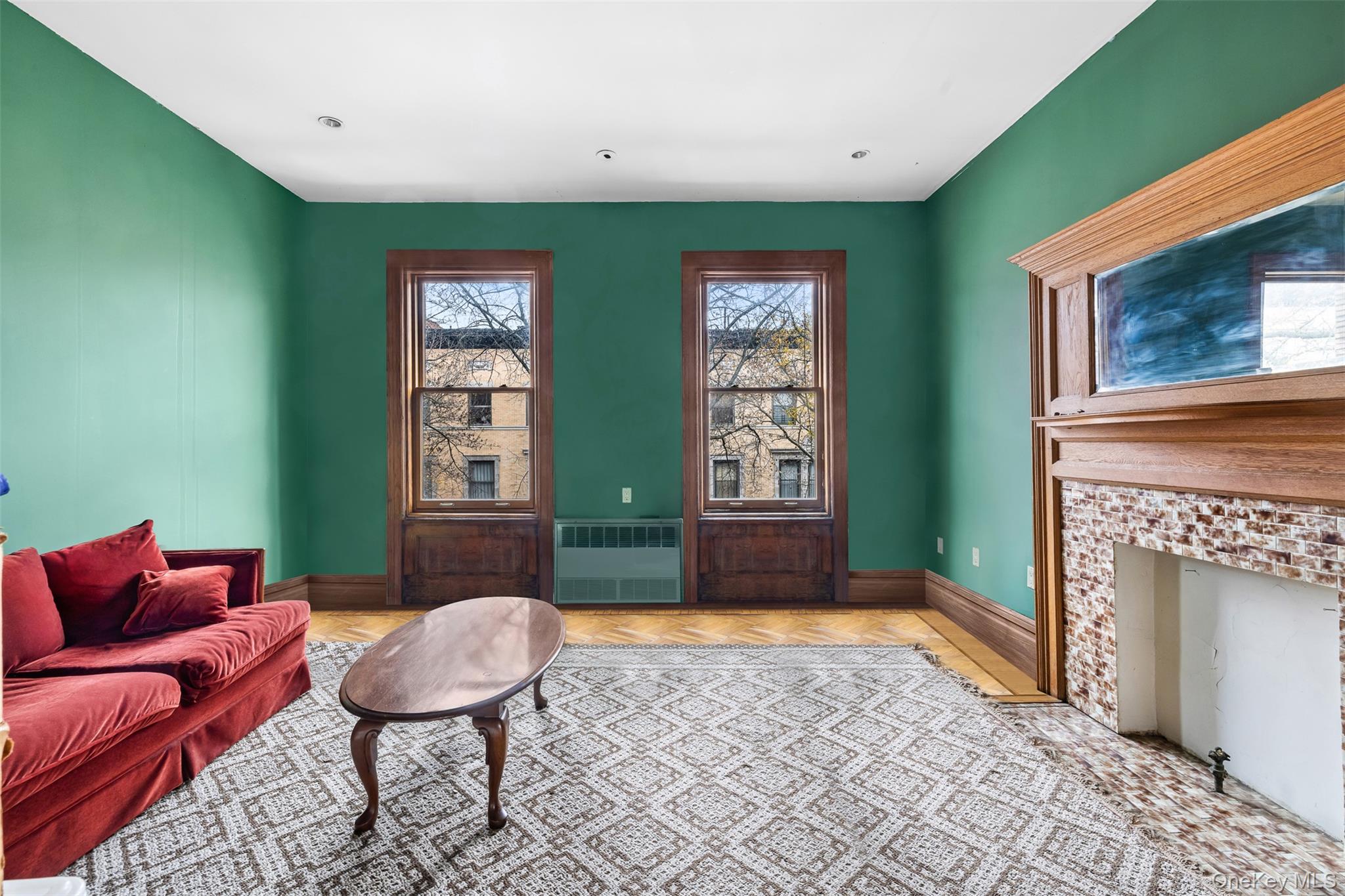 28 Hamilton Terrace Manhattan, NY 10031 - Photo 8 of 11 a living room with furniture and a fireplace