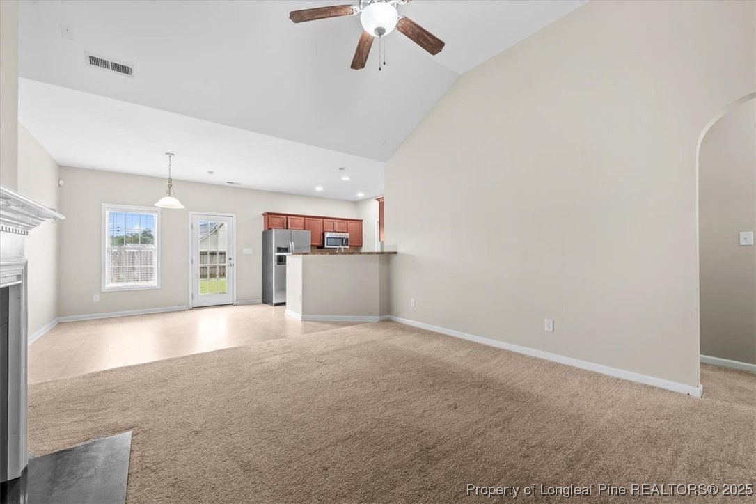 370 Roanoke Drive Raeford, NC 28376 - Photo 4 of 26 an empty room with windows and ceiling fan