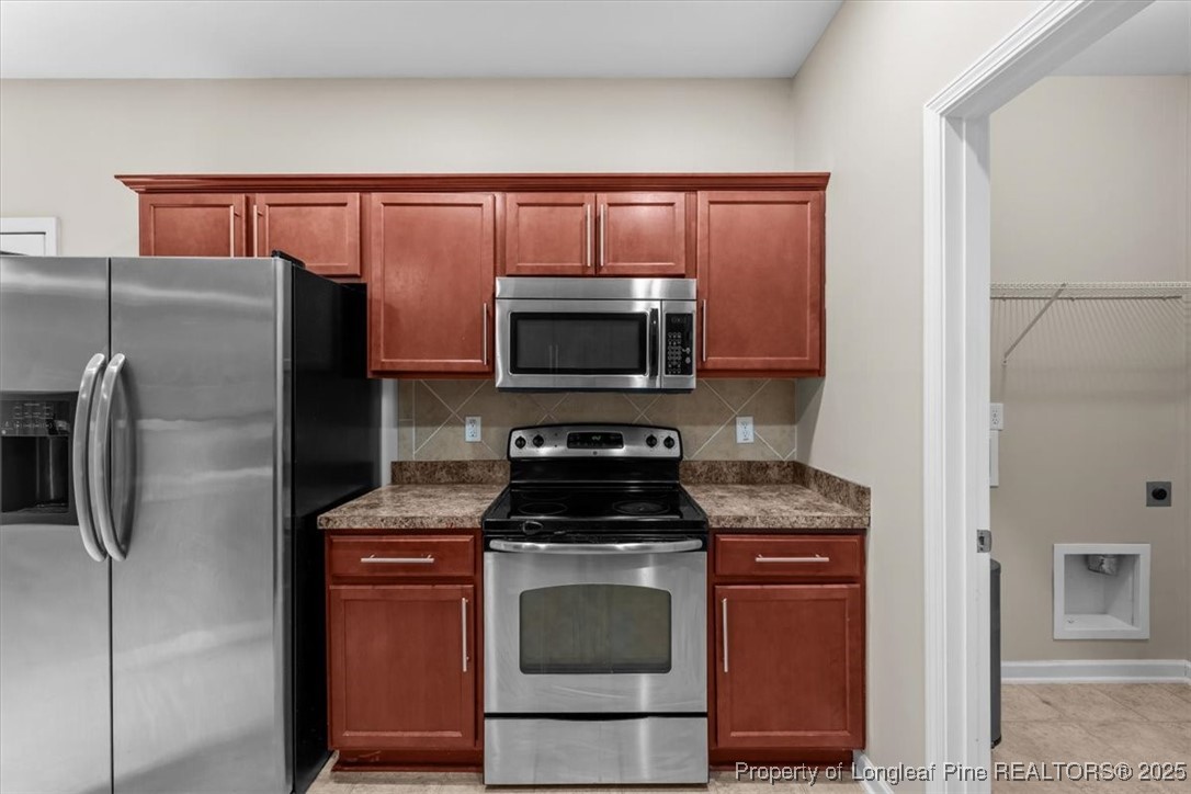 370 Roanoke Drive Raeford, NC 28376 - Photo 10 of 26 a kitchen with granite countertop a refrigerator stove and microwave