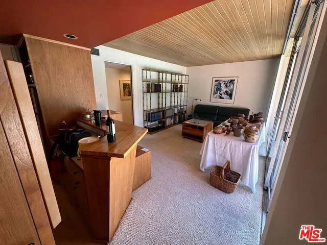 a bedroom with furniture and a large window