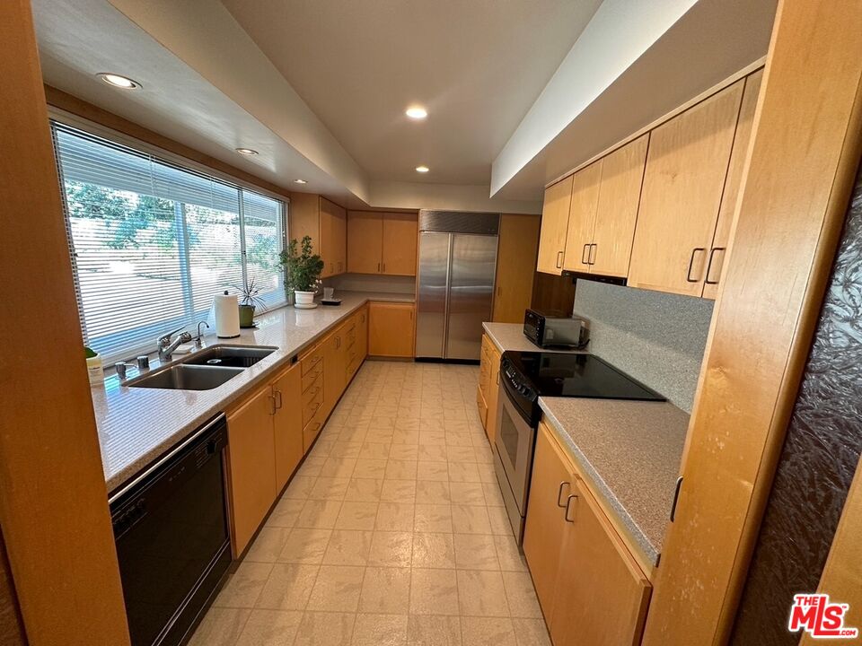 590 North Tigertail Road Los Angeles, CA 90049 - Photo 15 of 69 a kitchen with sink a counter top space and appliances