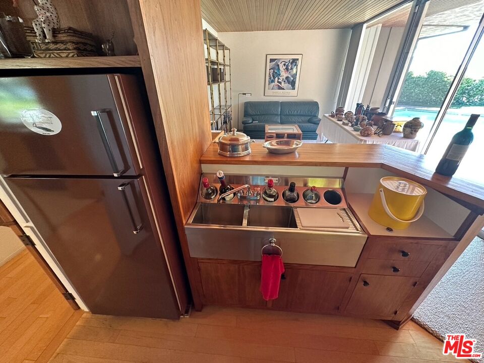 590 North Tigertail Road Los Angeles, CA 90049 - Photo 23 of 69 a view of living room with furniture and a floor to ceiling window