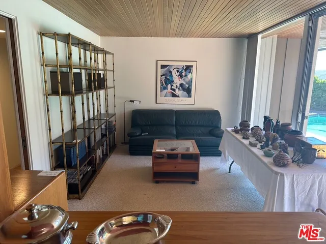 a lobby with furniture and floor to ceiling window